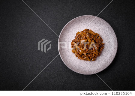 Delicious asian udon dish with vegetables, mushrooms, salt and spices 110255104