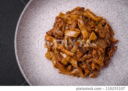 Delicious asian udon dish with vegetables, mushrooms, salt and spices 110255107