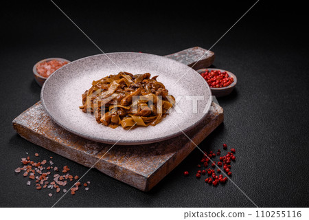 Delicious asian udon dish with vegetables, mushrooms, salt and spices Delicious asian udon dish with vegetables, mushrooms, salt and spices 110255116
