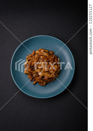 Delicious asian udon dish with vegetables, mushrooms, salt and spices 110255127