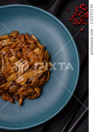 Delicious asian udon dish with vegetables, mushrooms, salt and spices 110255134