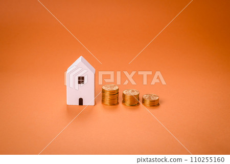 A small wooden house and keys as an idea for investing in your own home A small wooden house and keys as an idea for investing in your own home 110255160