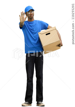 A male deliveryman, on a white background, in full height, with a box, shows a stop sign A male deliveryman, on a white background, in full height, with a box, shows a stop sign 110255201