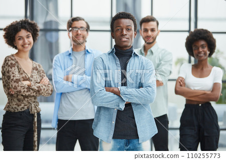 a group of successful business diverse people in the office stands embracing a group of successful business diverse people in the office stands embracing 110255773