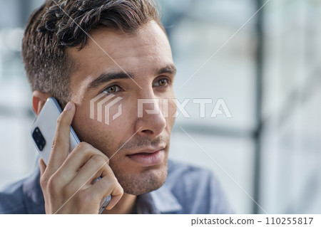 Businessman shopping over the phone in an office Businessman shopping over the phone in an office 110255817