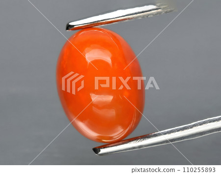 natural fire orange opal gem on the background 110255893