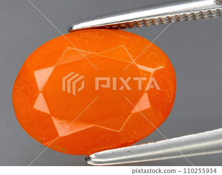 natural fire orange opal gem on the background 110255934