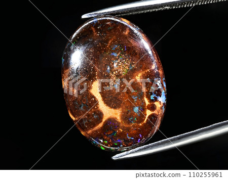 natural multicolor boulder opal gem on the background 110255961