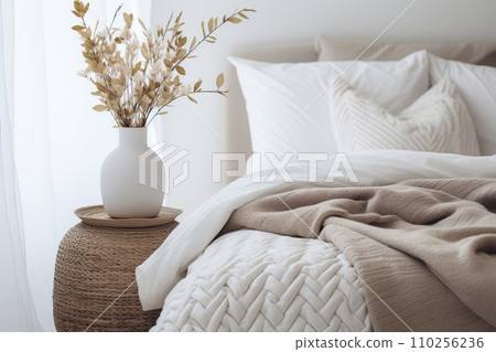 AI-generated content. Neutral Scandi-style interior with hygge furniture in the bedroom. Linen bed or bedding. Close up interior details photo. Dried flowers in a vase for interior decoration. 110256236