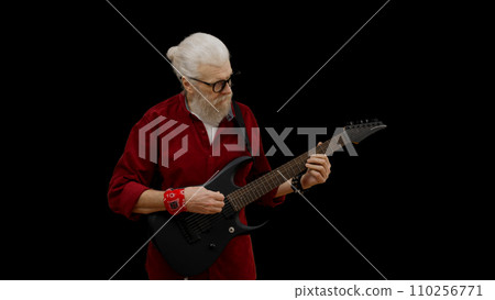 Man in his 60s plays the electric guitar, embodying the spirit of forever young and rock and roll Man in his 60s plays the electric guitar, embodying the spirit of forever young and rock and roll 110256771