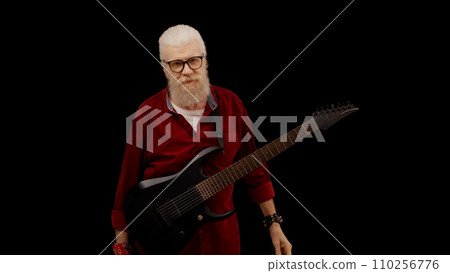 Exhausted senior man stops playing the electric guitar, struggling with notes and chords 110256776