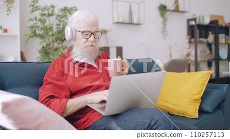 Contemporary senior man works from home, embodying the role of a freelancer and IT specialist 110257113