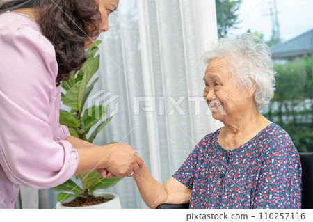 Caregiver help Asian senior woman on wheelchair with love at home. Caregiver help Asian senior woman on wheelchair with love at home. 110257116