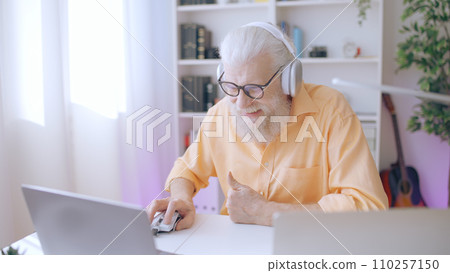 A geeky senior man indulges in his passion for gaming, enjoying his leisure time with his favorite hobby A geeky senior man indulges in his passion for gaming, enjoying his leisure time with his favorite hobby 110257150