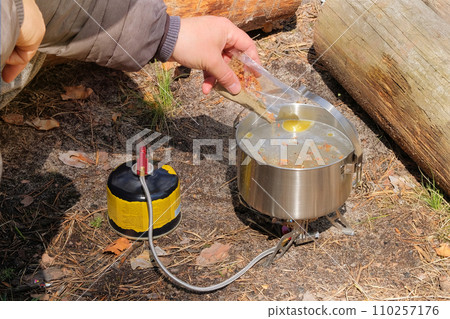 Traveler foods in outdoor activities. Food in bowler in the green forest. Camping food making. 110257176