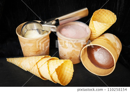 This image shows three cups of ice cream in different flavors 110258154