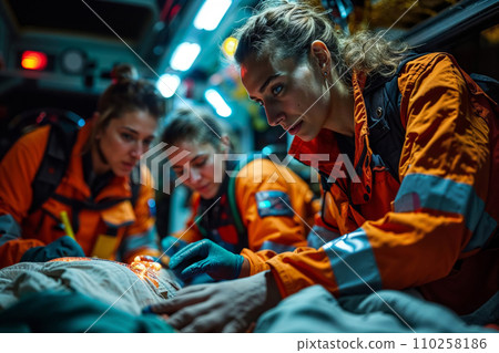EMS Paramedics providing professional medical care to a injured patient inside ambulance on the way to Hospital. EMS Paramedics providing professional medical care to a injured patient inside ambulance on the way to Hospital. 110258186