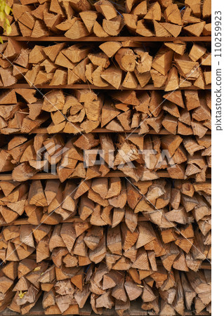 A stack of stacked firewood 110259923