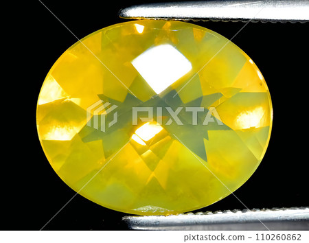 natural fire yellow opal gem on the background natural fire yellow opal gem on the background 110260862