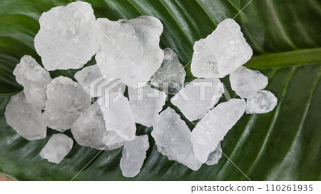 White alum cubes or Potassium alum on green leaf White alum cubes or Potassium alum on green leaf 110261935