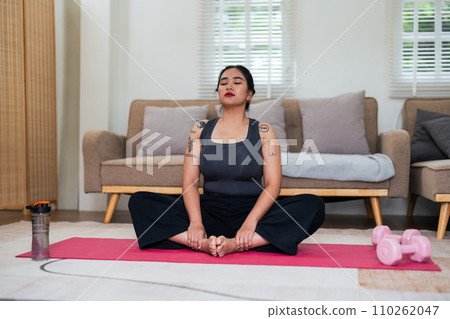 Asian overweight woman doing stretching exercise at home on fitness, Stretching training workout on yoga mat at home for good health and body shape 110262047