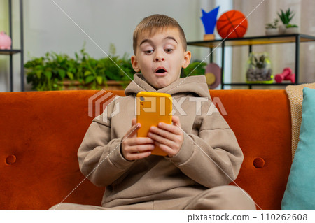 Young child kid boy texting share messages content on smartphone social media applications online 110262608