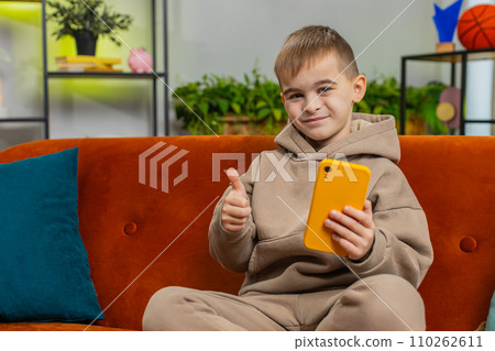 Young child kid boy texting share messages content on smartphone social media applications online 110262611