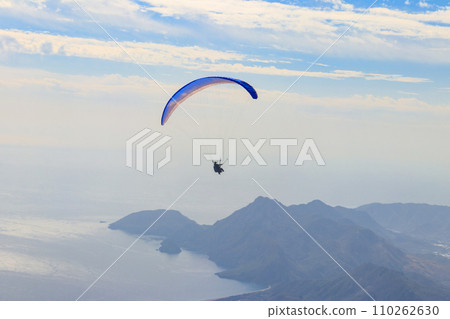 Paragliders flying from a top of Tahtali mountain near Kemer, Antalya Province in Turkey. Concept of active lifestyle and extreme sport adventure Paragliders flying from a top of Tahtali mountain near Kemer, Antalya Province in Turkey. Concept of active lifestyle and extreme sport adventure 110262630