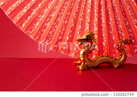 2024 Chinese New Year with Oriental Dragon, folding fan on red background 110262734
