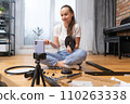The girl is confused and consults by video link trying to assemble furniture. 110263338