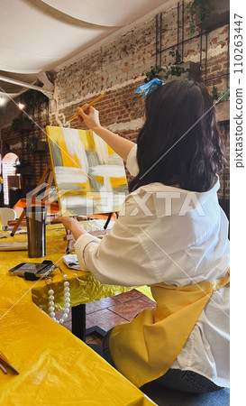 Woman with brush painting on canvas Woman with brush painting on canvas 110263447