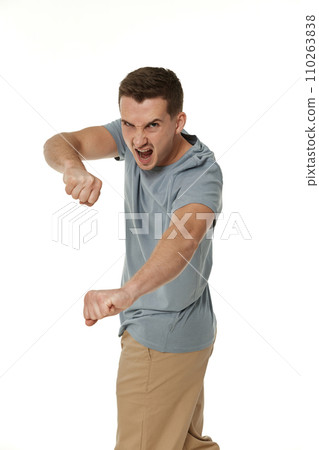 annoyed angry man fighting on white studio background 110263838