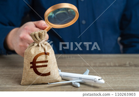 Airplane and euro money bag under investigation. Economic impact of aviation industry. Environmental footprint. Payment of taxes, fees and excise taxes. Measure impact on local economy. Airplane and euro money bag under investigation. Economic impact of aviation industry. Environmental footprint. Payment of taxes, fees and excise taxes. Measure impact on local economy. 110263903
