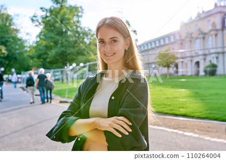 Portrait of young teenage female looking at camera outdoor 110264004