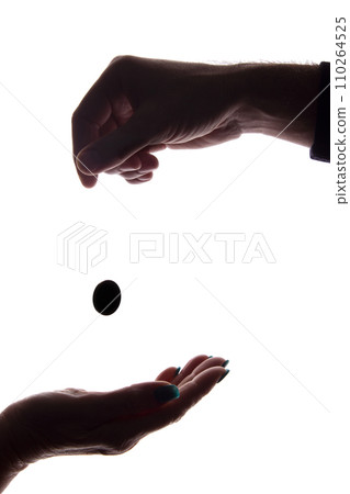 Young man's hand with a coin gives alms - silhouette, help Young man's hand with a coin gives alms - silhouette, help 110264525