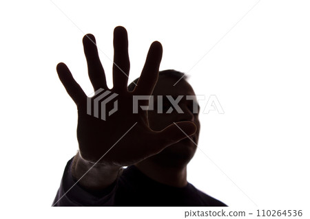 Hand young man covers his face, protest - silhouette, concept Hand young man covers his face, protest - silhouette, concept 110264536