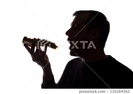Portrait of a young man eat pizza, side view - silhouette Portrait of a young man eat pizza, side view - silhouette 110264562