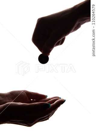 Young man's hand with a coin gives alms - silhouette, help Young man's hand with a coin gives alms - silhouette, help 110264579