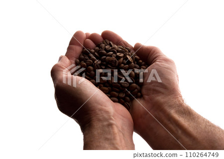 Man's hand a handful of coffee beans - silhouette Man's hand a handful of coffee beans - silhouette 110264749