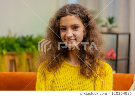 Portrait of happy smiling Caucasian 15 years school girl child kid looking at camera, home play room 110264985