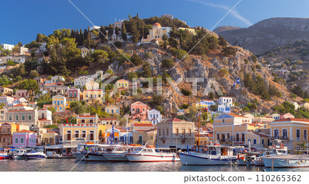 Multi-colored facades of houses in the village of Symi at sunset. Multi-colored facades of houses in the village of Symi at sunset. 110265362