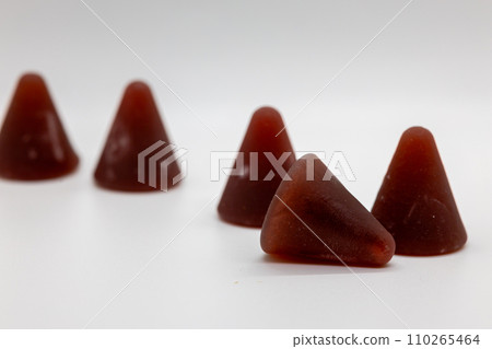 Closeup of cuberdon, a cone-shaped Belgian candy on a white background 110265464