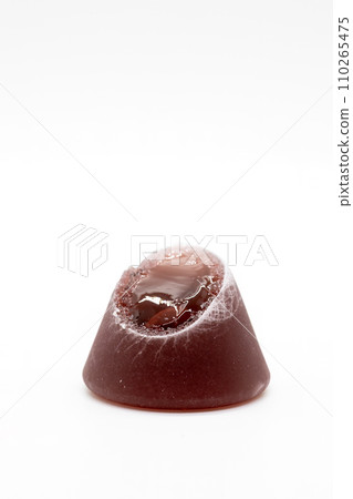 Closeup of cuberdon, a cone-shaped Belgian candy on a white background Closeup of cuberdon, a cone-shaped Belgian candy on a white background 110265475