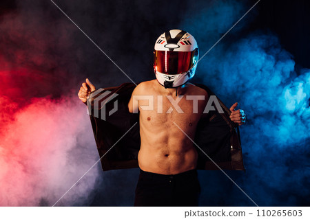 Male motorcyclist wearing helmet in smoke Male motorcyclist wearing helmet in smoke 110265603