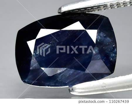 natural dark blue sapphire gem on the background natural dark blue sapphire gem on the background 110267439
