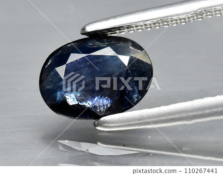 natural dark blue sapphire gem on the background 110267441
