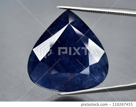 natural dark blue sapphire gem on the background natural dark blue sapphire gem on the background 110267455