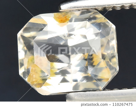 natural yellow sapphire gem on the background natural yellow sapphire gem on the background 110267475