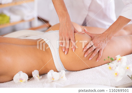 Close-up of young woman getting massage on her thighs and buttocks 110269501