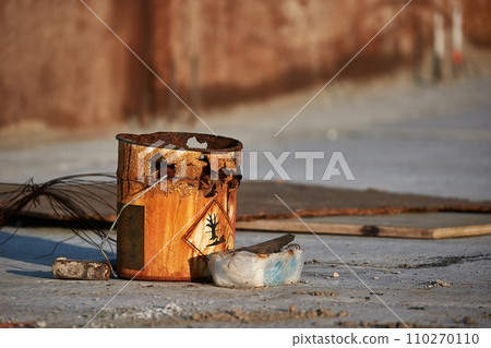 Rusty bucket remains at a construction site Rusty bucket remains at a construction site 110270110